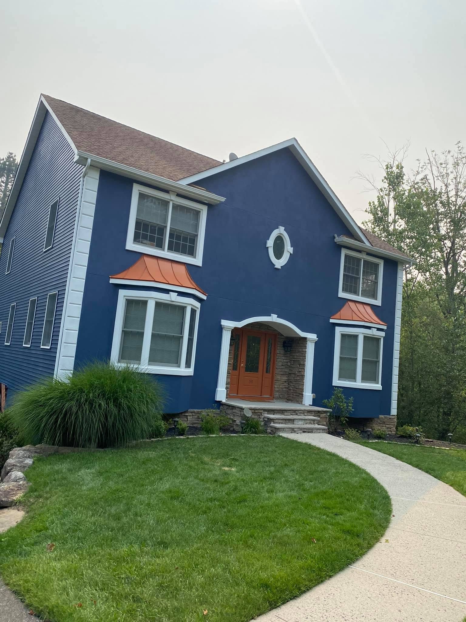 Blue exterior house with white painted trim