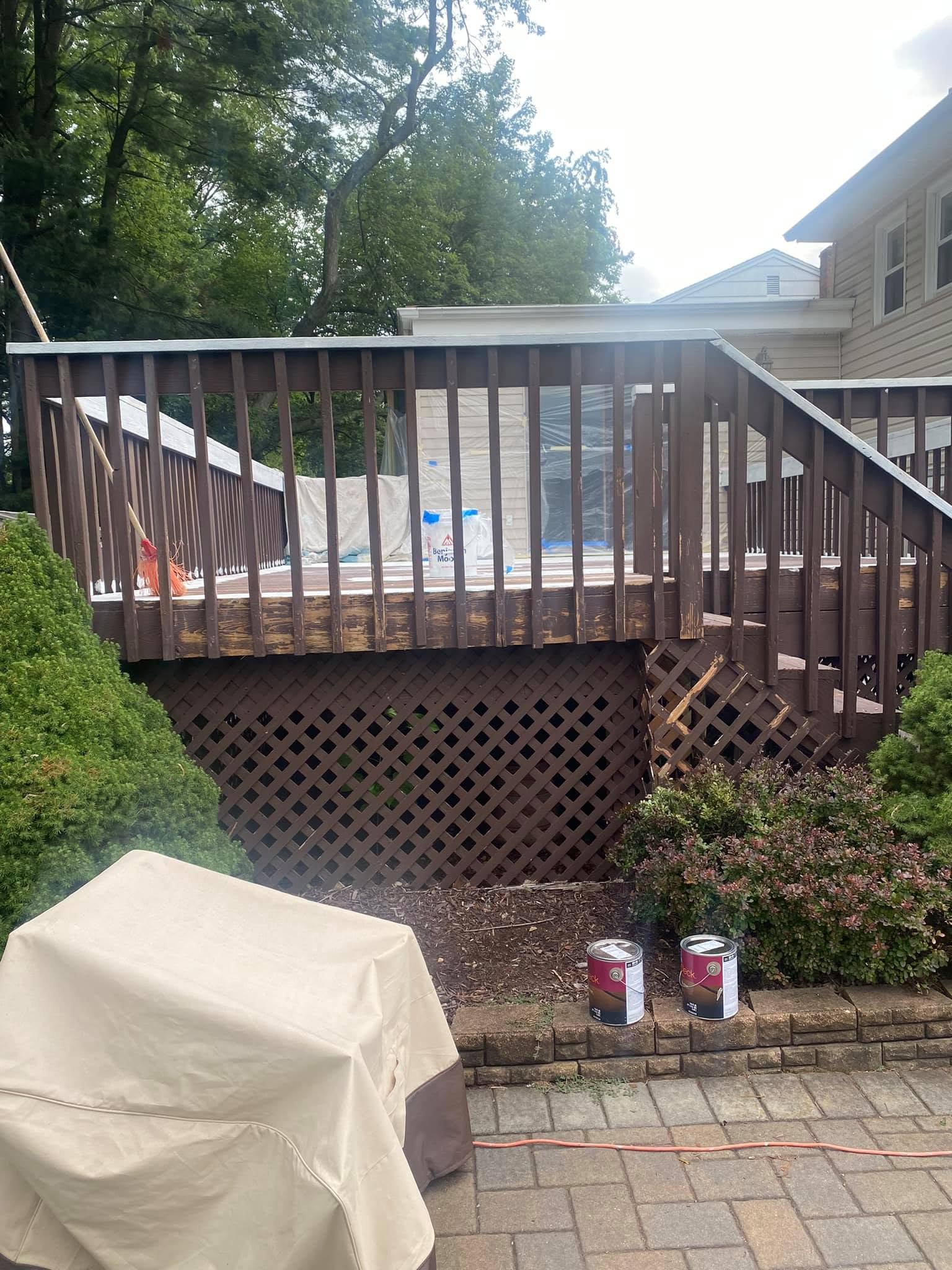 Dark brown deck railing and lattice before refinishing